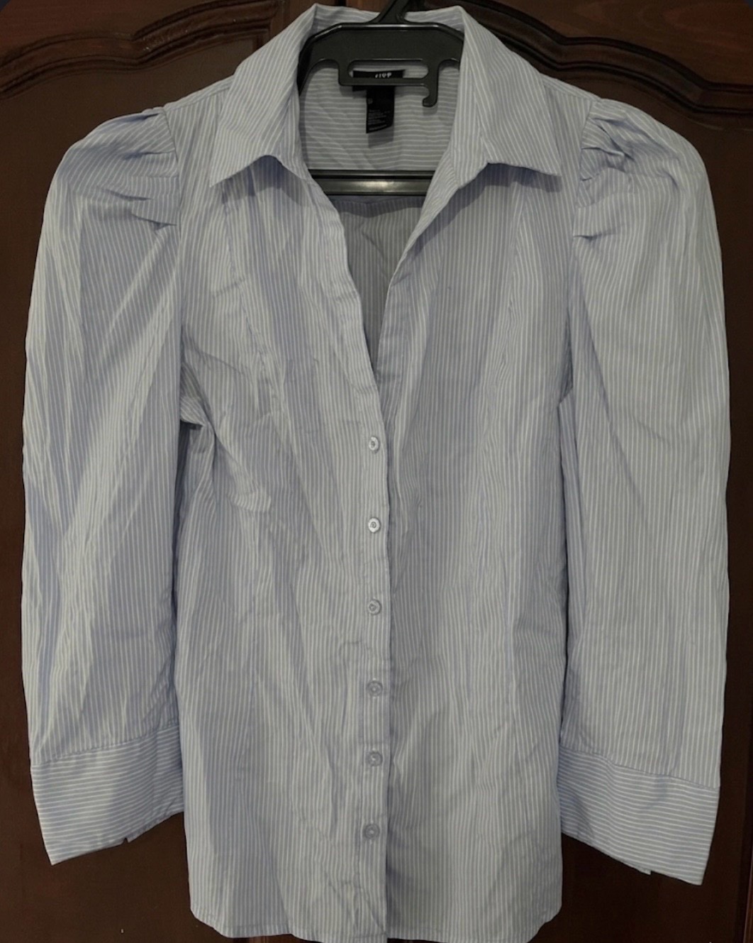 A light blue and white striped button-down shirt with puff sleeves