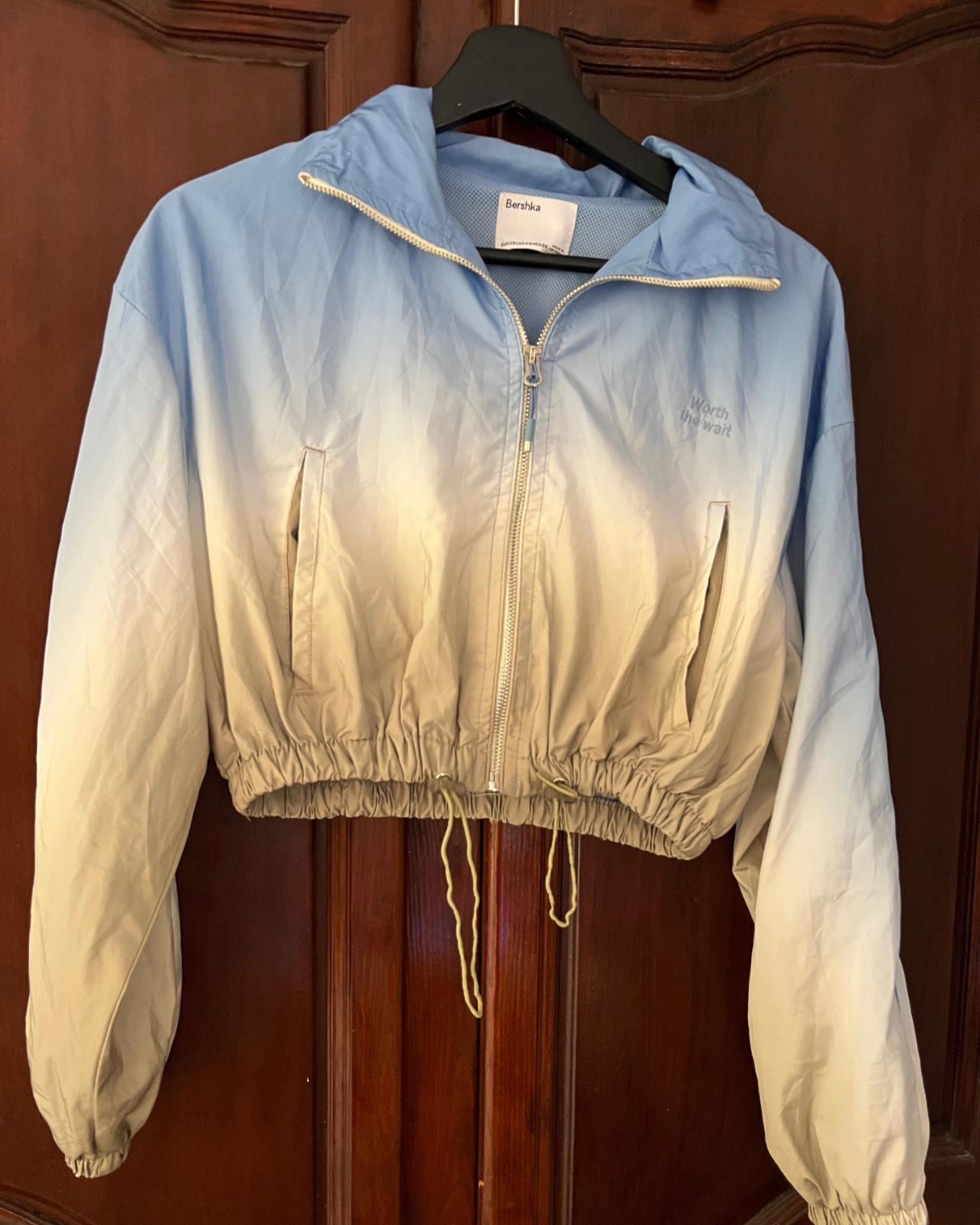 Light, blue-to-beige gradient cropped windbreaker jacket from Bershka
