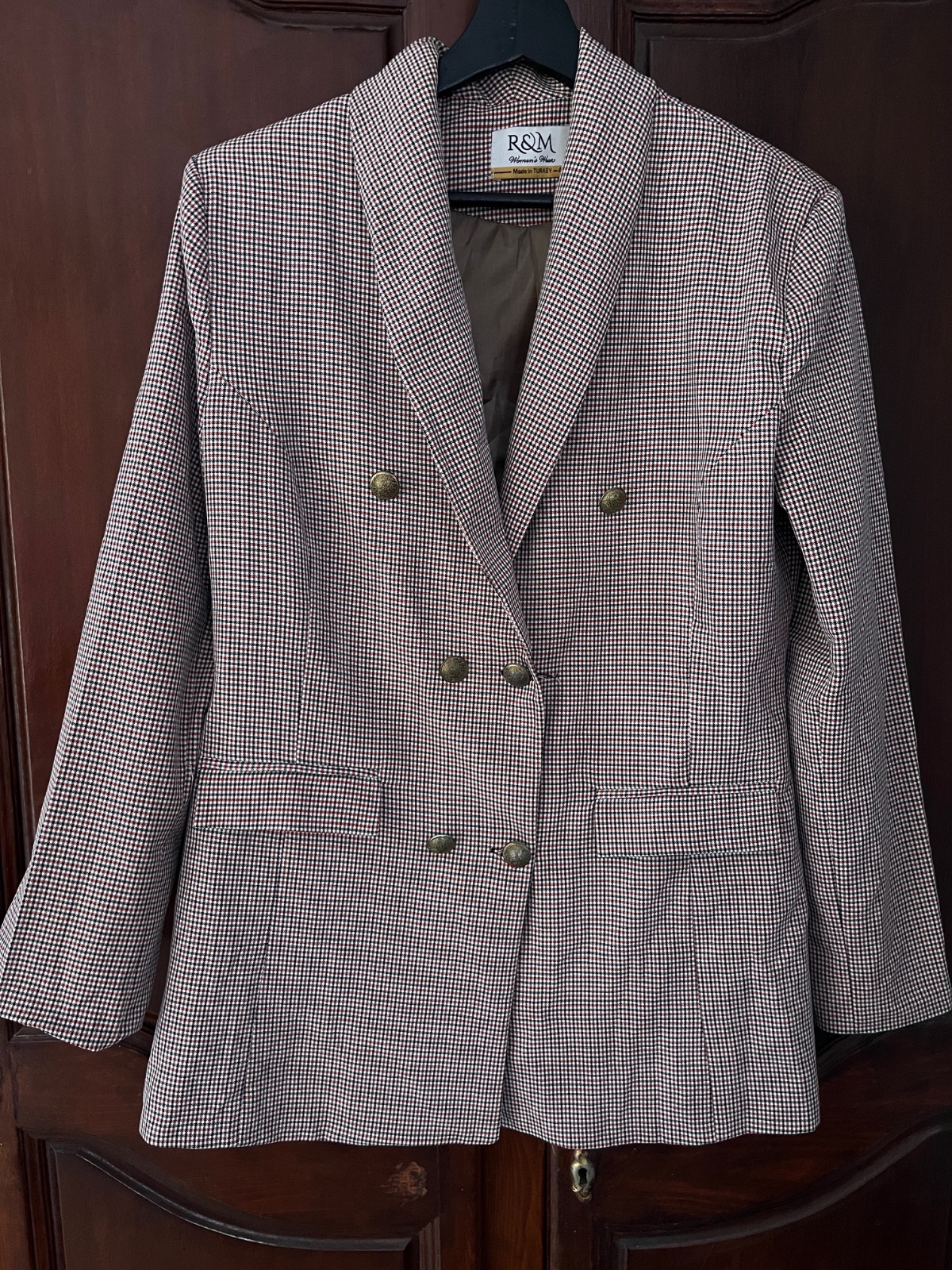 A double-breasted blazer from R&M Women's Wear featuring a brown mini-check pattern and textured metallic buttons