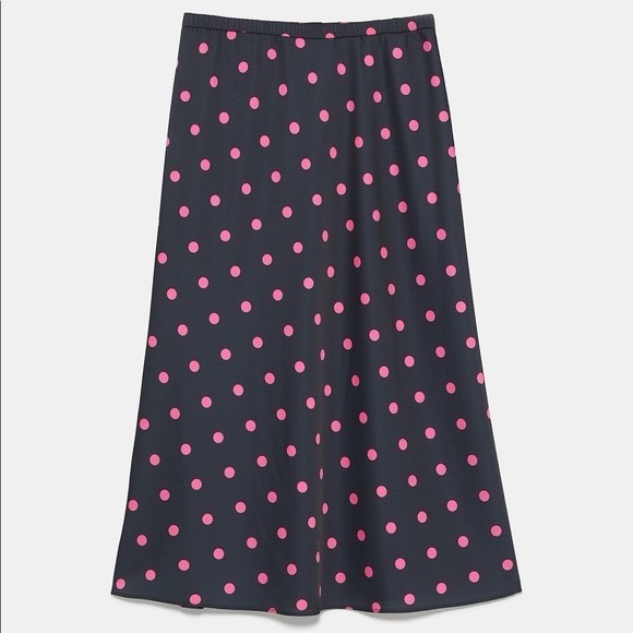 A black Zara midi skirt features a vibrant pink polka dot pattern and an elasticated waistband