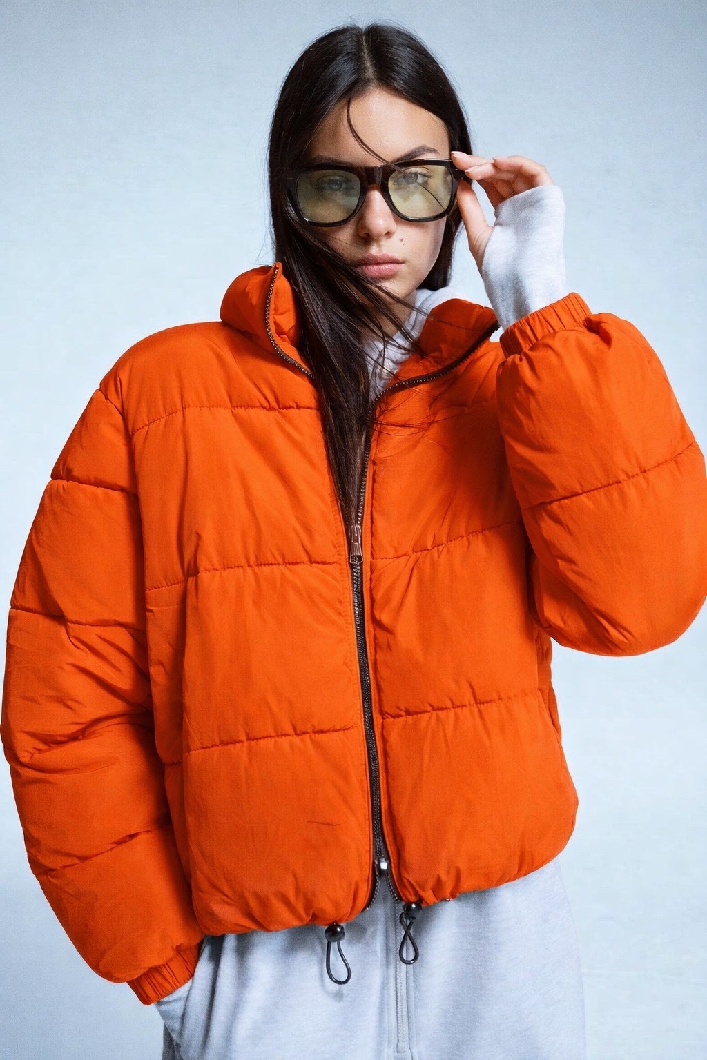 Bright orange cropped puffer jacket from Bershka