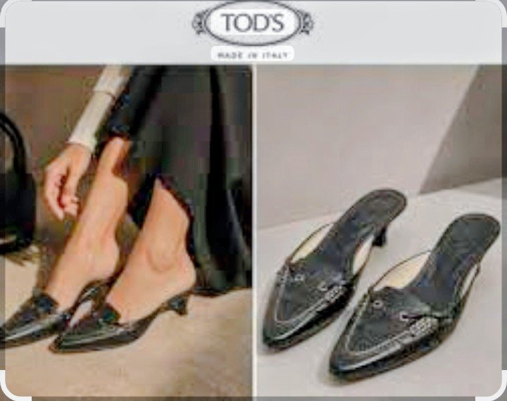 Vintage Tod's black leather loafer mules resting on top of a brown branded Tod's dustbagvintage Tod's black leather loafer mules resting on top of a brown branded Tod's dustbag