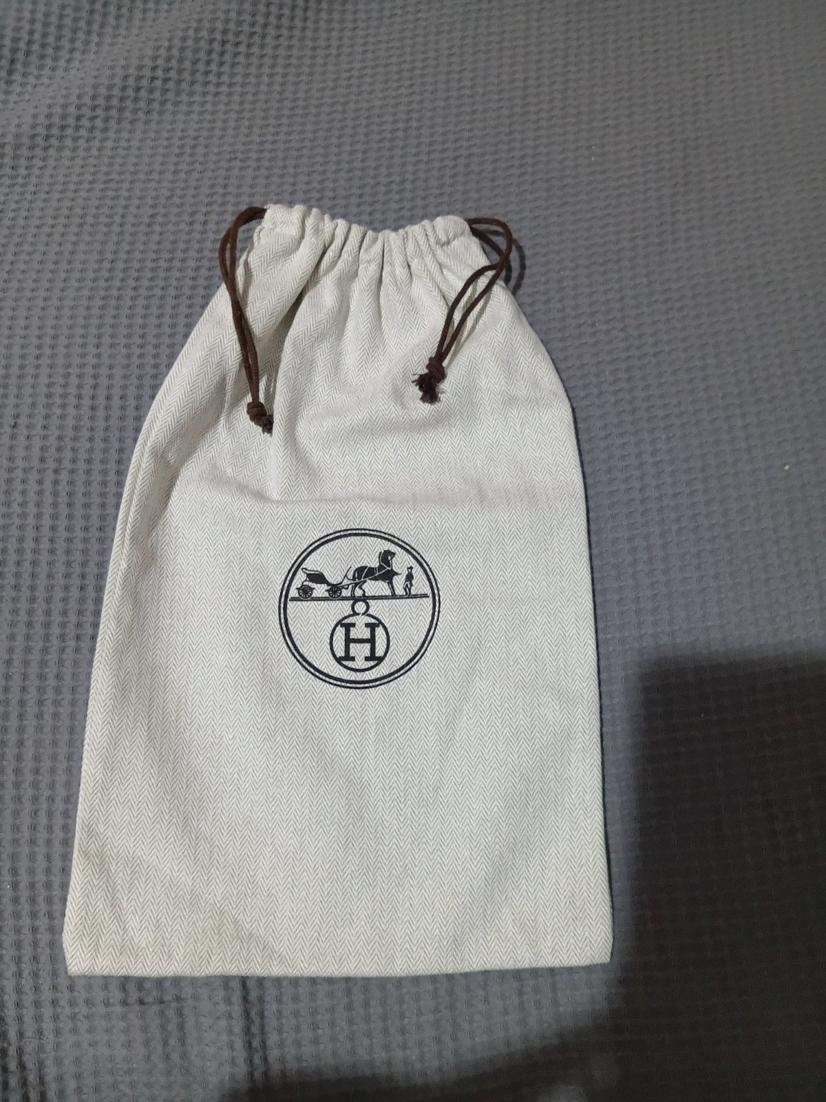 Authentic Hermès herringbone cotton dust bag (or dust cover) used to store and protect luxury items like shoes, wallets, or handbags