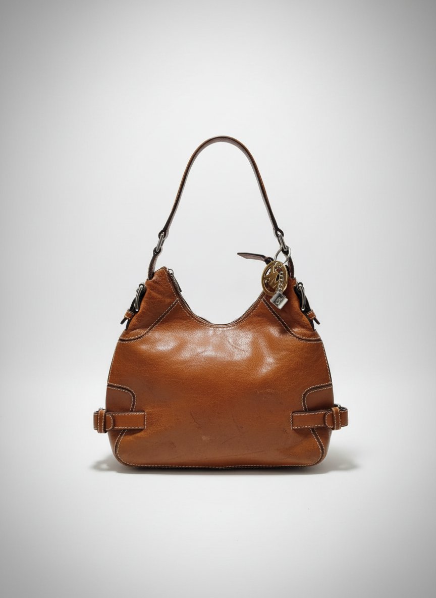 The item in the selected region is a Vintage Michael Kors Brookville Leather Hobo Bag, featuring a slouchy silhouette crafted from tan/brown leather with contrasting white topstitching, decorative side buckles, and signature hanging logo charms.👜