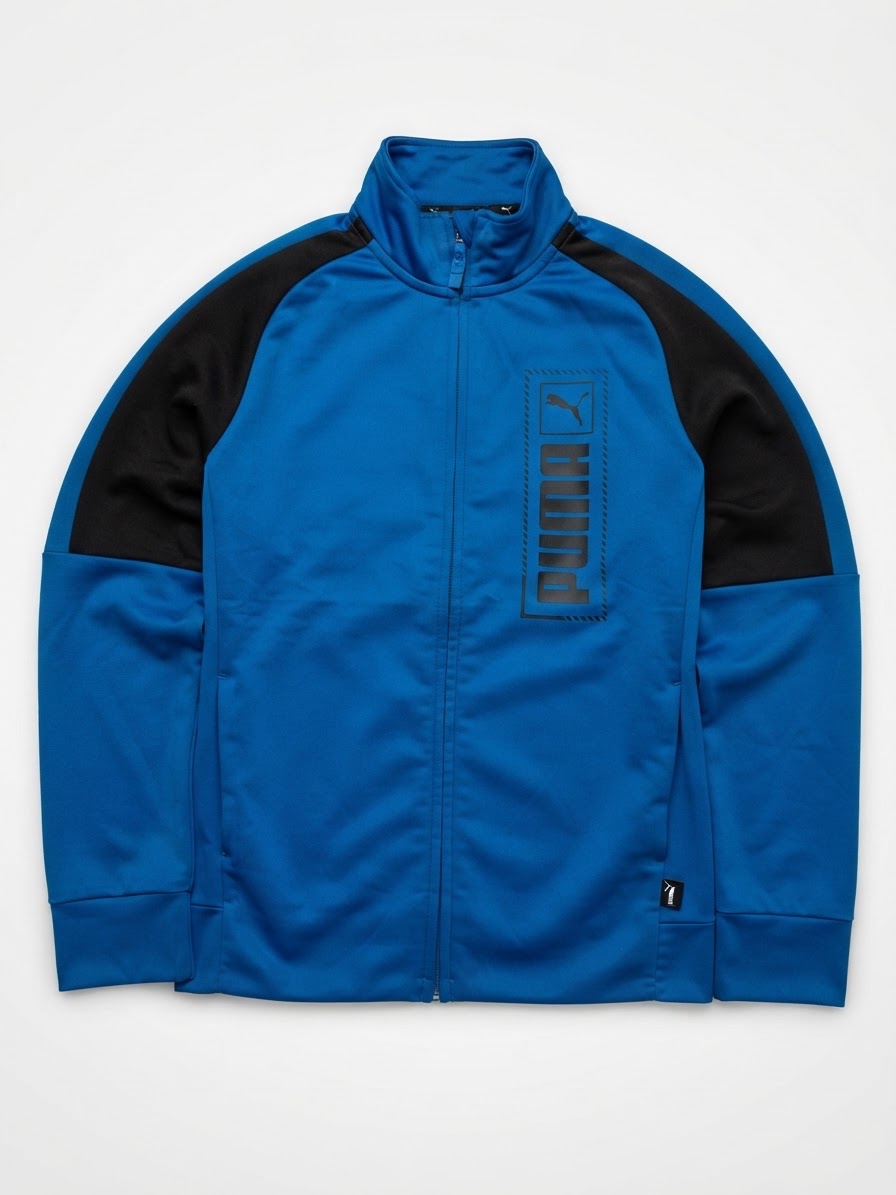 Veste de survêtement zippée Puma pour enfant, de couleur bleu roi et noire avec des empiècements noirs sur les épaules