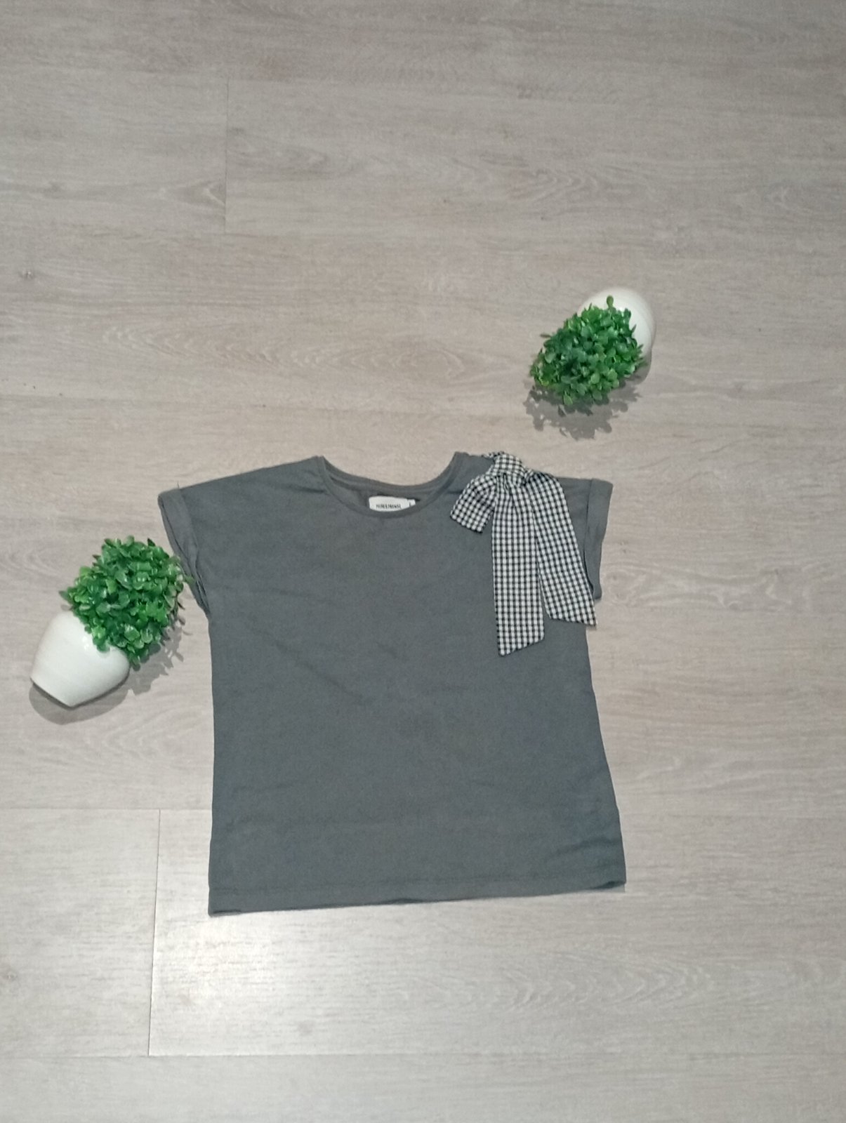 T-shirt femme gris avec joli nœud à carreaux.