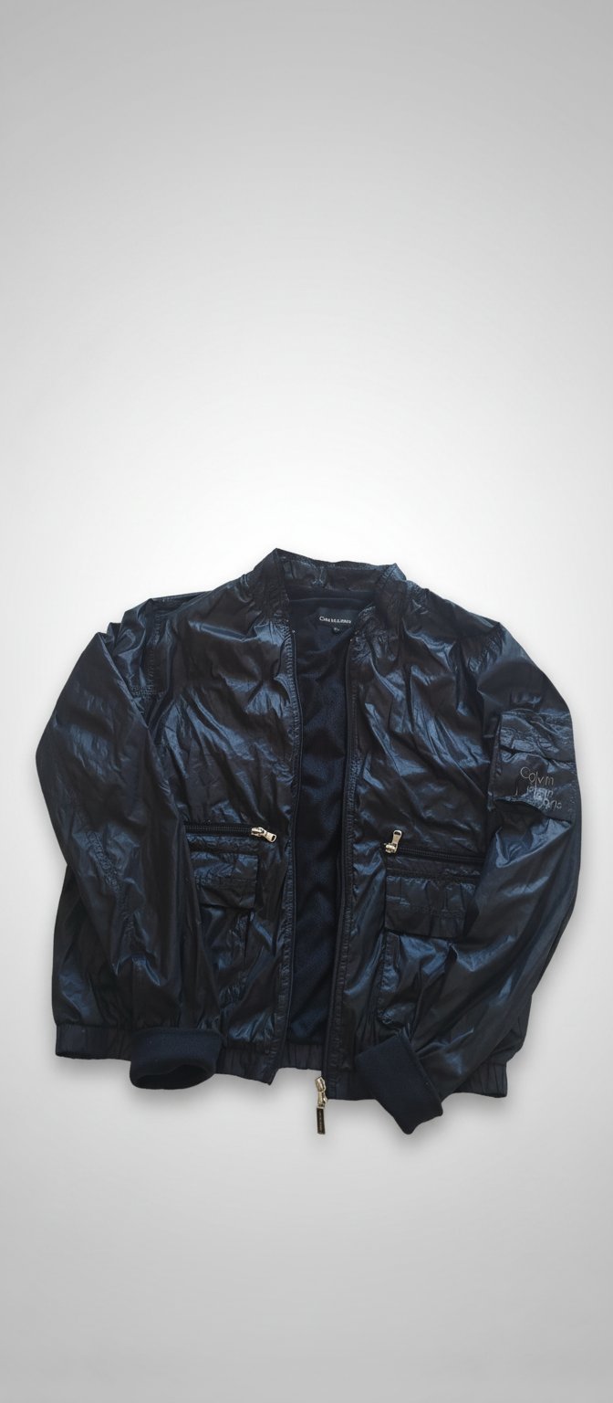 Blouson imperméable CK la serrure un peu usé mais fonctionnel 