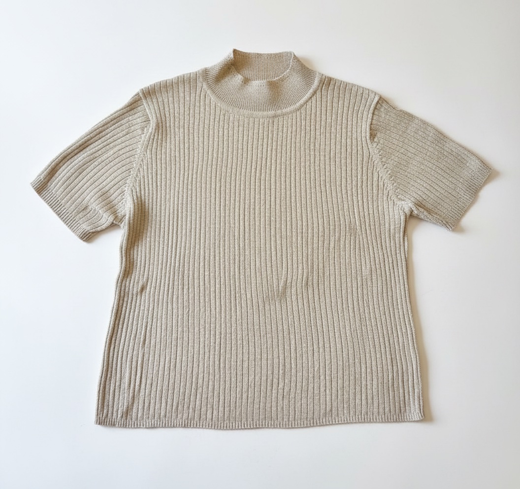 Pull doré doux à manches courtes se distingue par son col montant et sa matière en maille côtelée brillante.taille 40/42/44