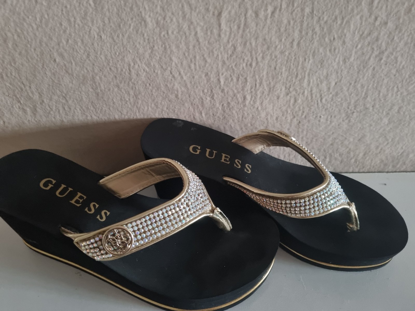 Gold Guess flip flops