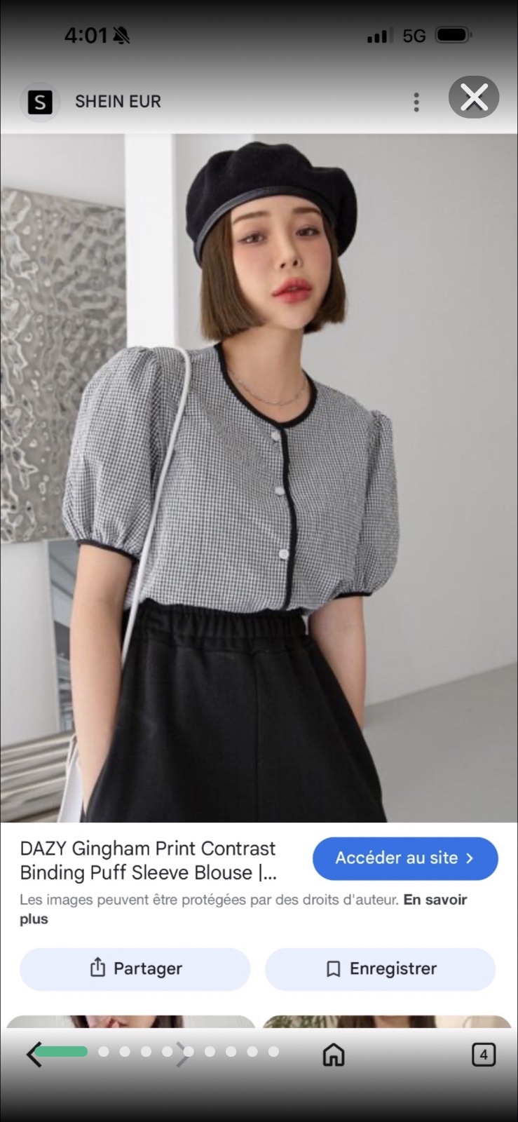 Chemisier à carreaux de la marque Dazy en motif vichy noir et blanc avec des manches bouffantes et une bordure noire contrastée