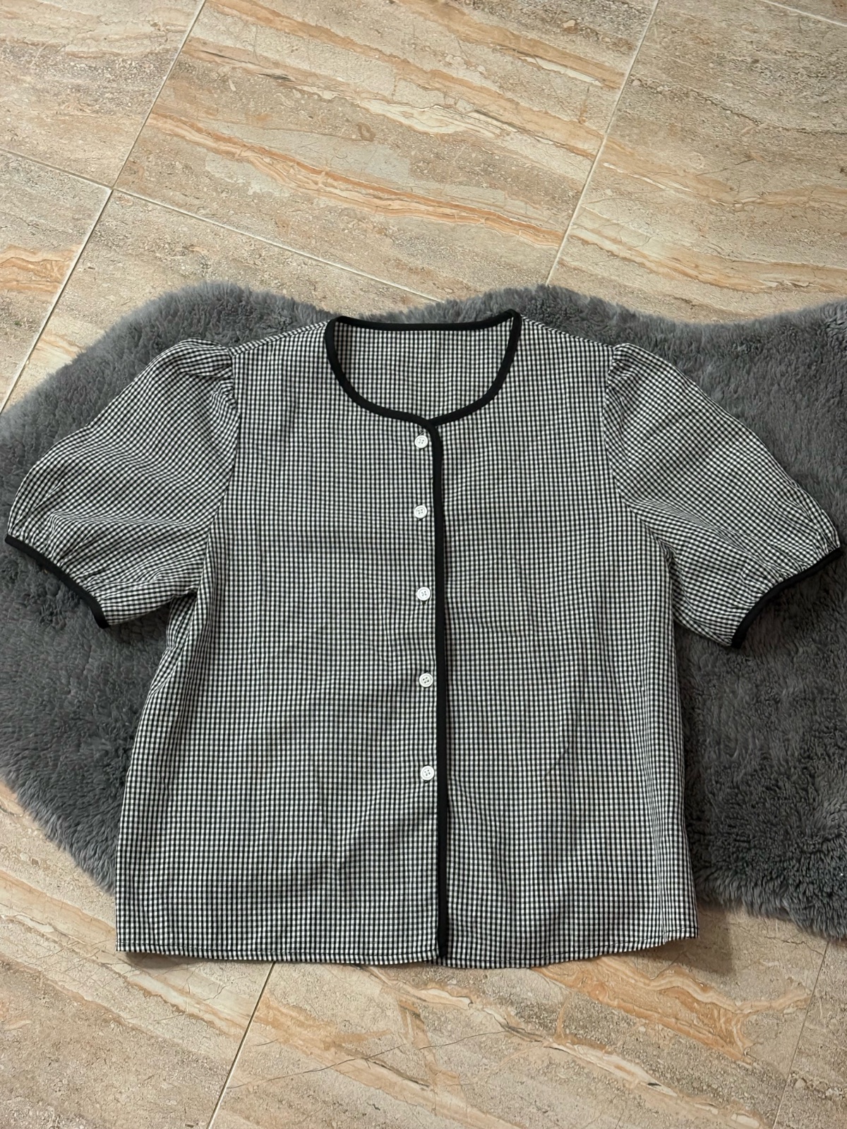 Chemisier de la marque DAZY à manches bouffantes, motif vichy noir et blanc avec passepoil