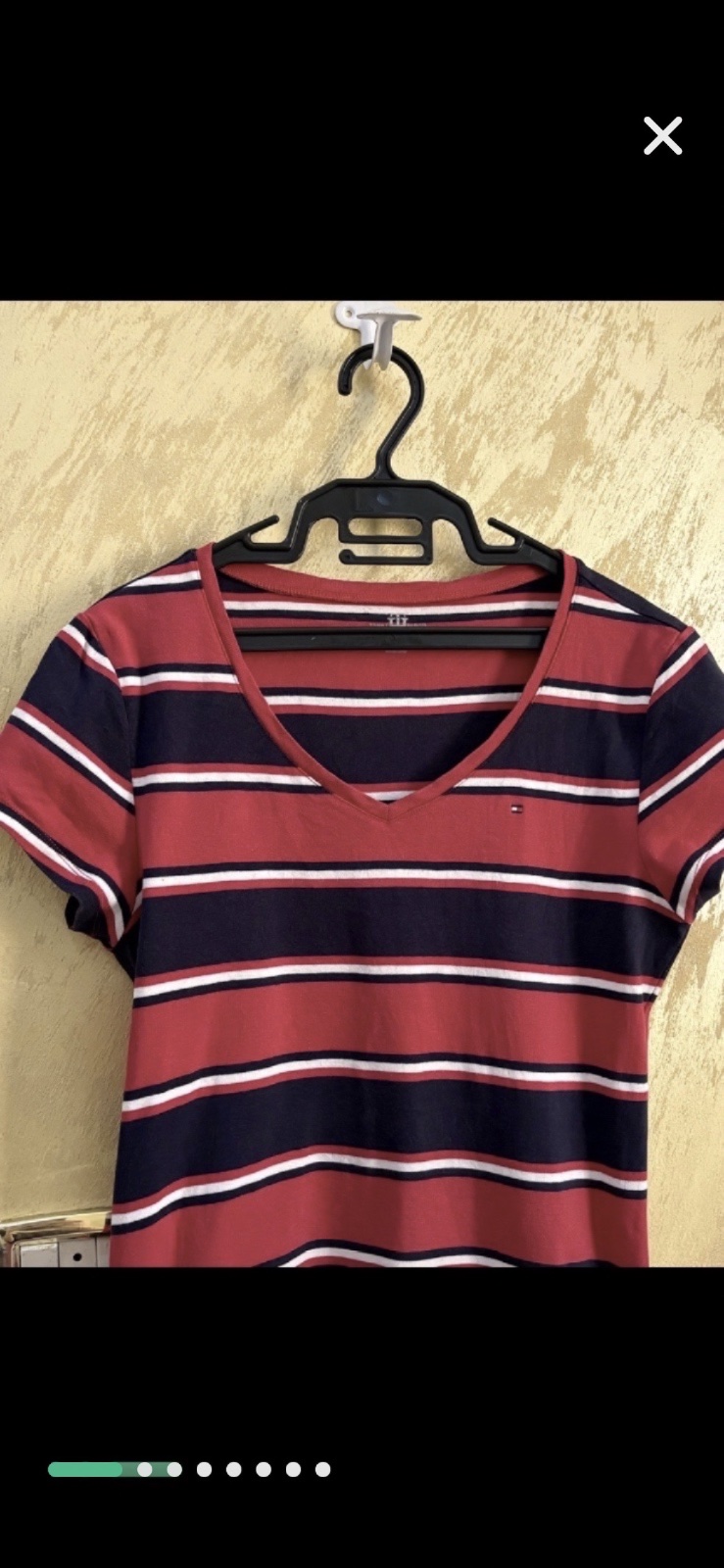 T-shirt Tommy Hilfiger arbore un motif rayé classique en rouge, bleu marine et blanc avec un col en V distinctif