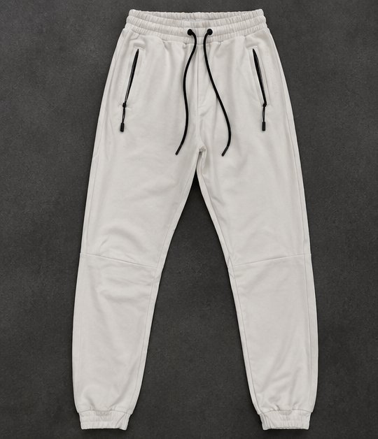 Jogging beige clair, confortable et stylé 🤍 Taille M, avec poches zippées et cordon ajustable. Idéal pour le sport ou un look décontracté.