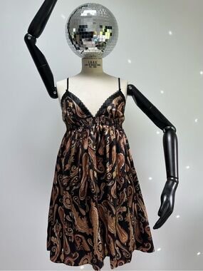  robe nuisette noire de chez La Vie en Rose présente un motif cachemire cuivré et des bretelles ornées de détails dorés