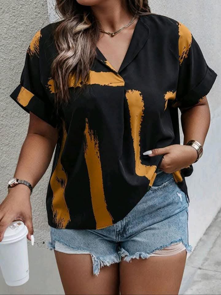 Blouse noire SHEIN se distingue par ses larges rayures orange en forme de coup de pinceau et ses manches relevées.