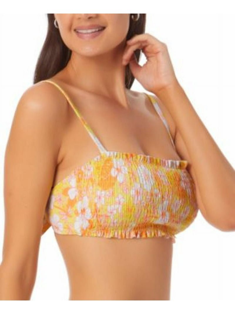 Un haut de maillot de bain ou d'un crop top de style bandeau froncé avec un motif floral aux couleurs vives.