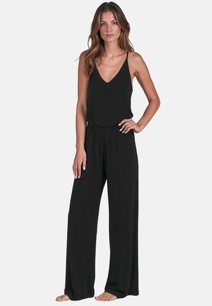 Combinaison-pantalon noire fluide à fines bretelles coton 100%