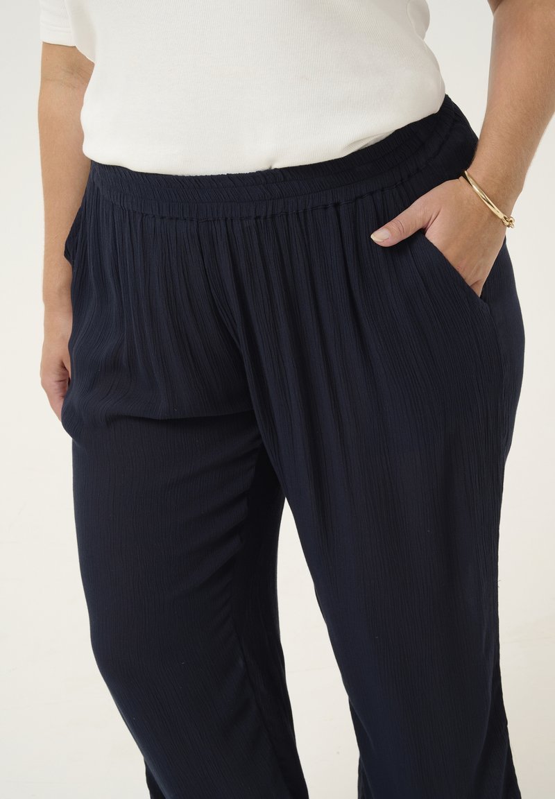 Pantalon H&M bleu fluide est fabriqué en viscose avec une taille élastiquée confortable.
