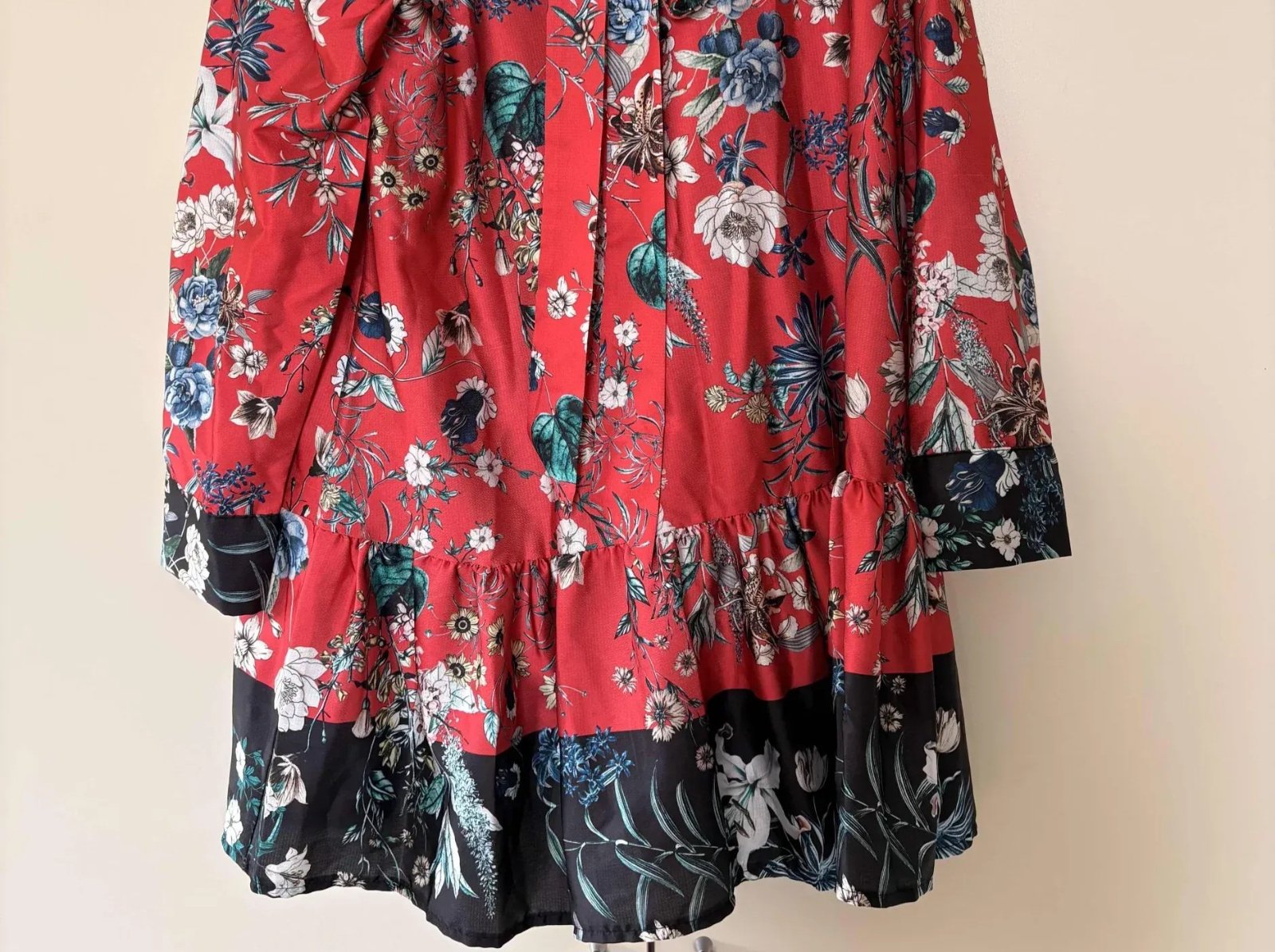 Une robe courte à fleurs rouge Look up avec une bordure noire et blanche. 