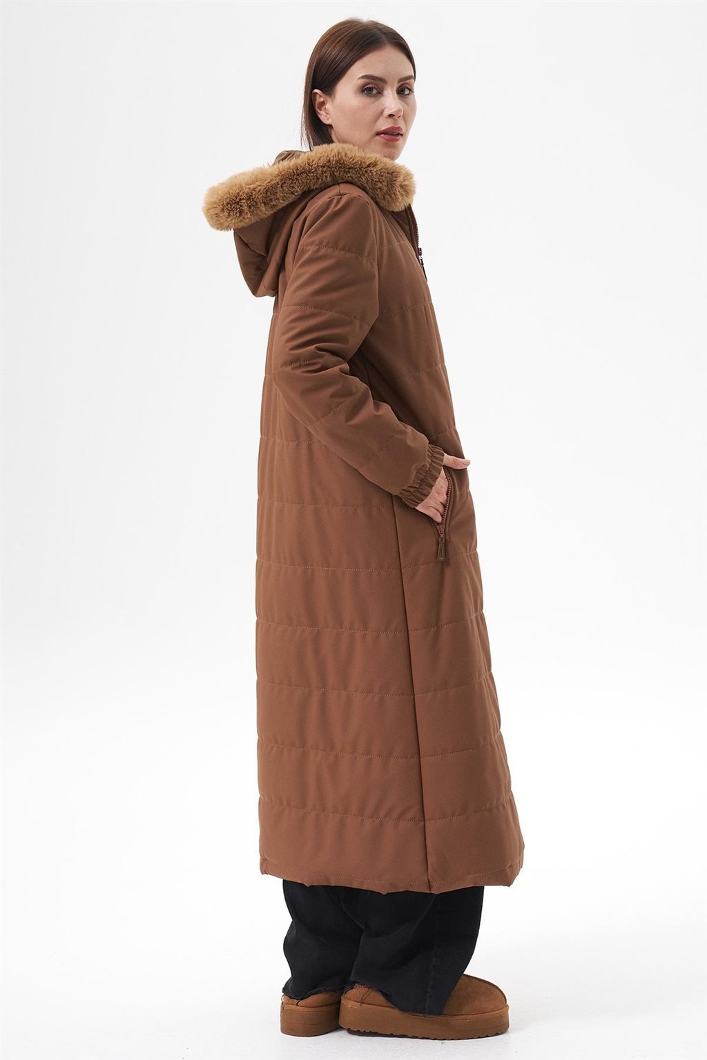 Un long manteau marron avec capuche bordée de fausse fourrure