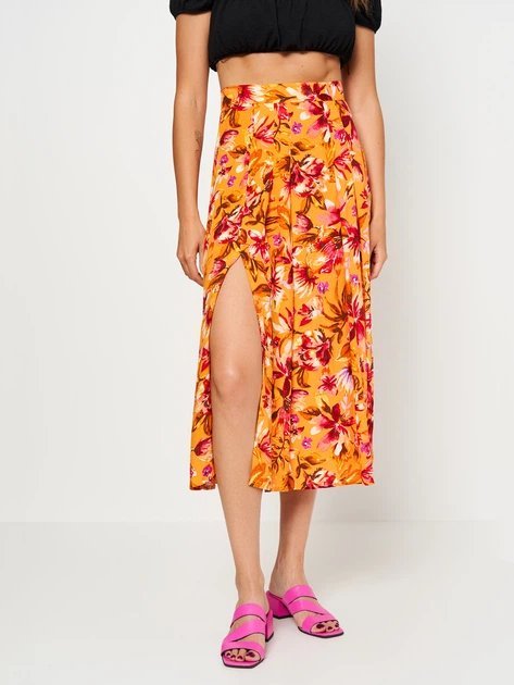 Jupe midi H&M orange à motif floral présente des fentes doubles latérales pour une allure estivale.