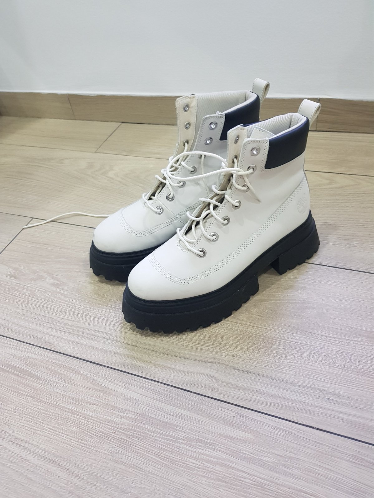 Bottines à lacets de la marque Timberland  en cuir blanc avec col en cuir noir et semelle crantée portées une seule fois pointure 39,5 