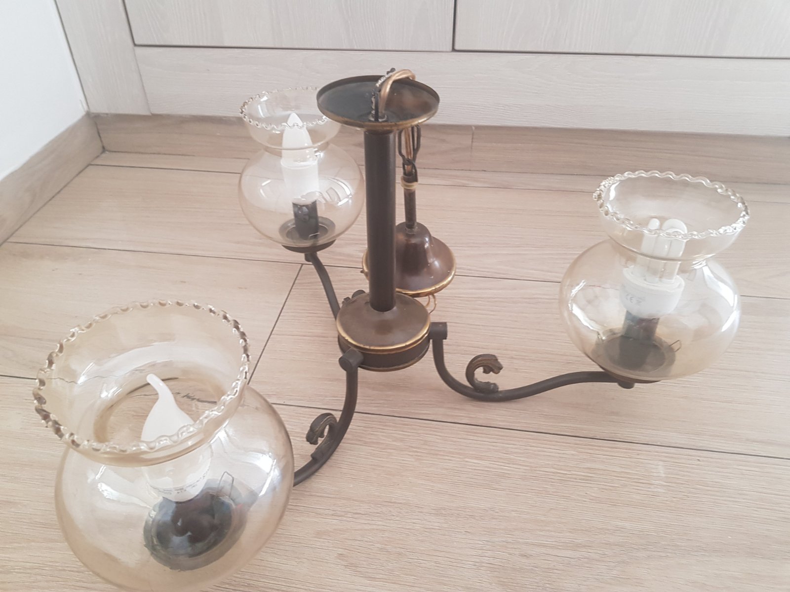 Lustre vintage à 3 branches en bronze  avec des abat-jours  en verre ambré à bord ondulé.