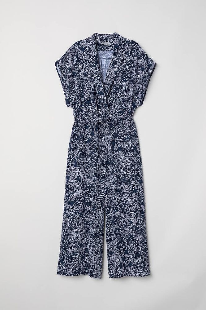 Combi-pants bleu avec un motif floral en blanc 