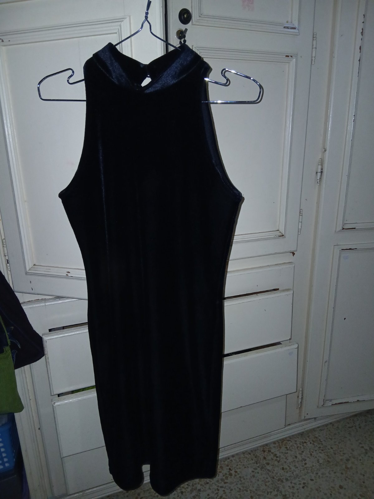 This is a black velvet, sleeveless halter-neck dress