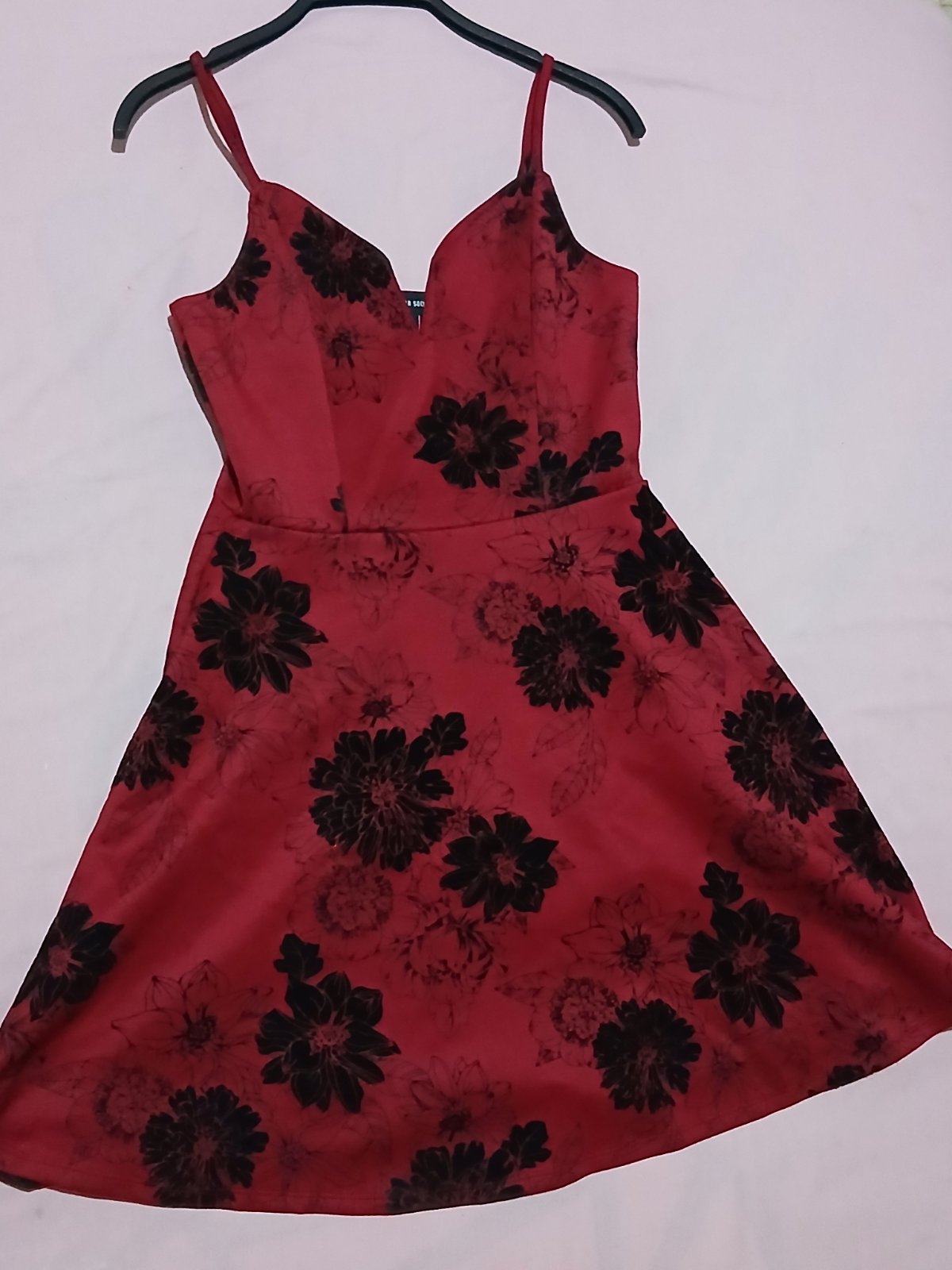 a red v-neck dress with black floral patterns