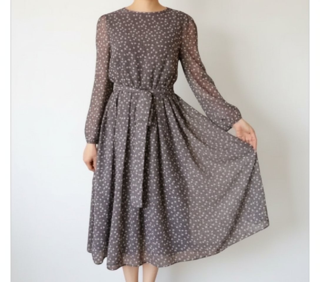 Jolie robe midi gris avec des petits pois en blanc les manches longues et transparentes et la robe possède une doublure taille 40/42 