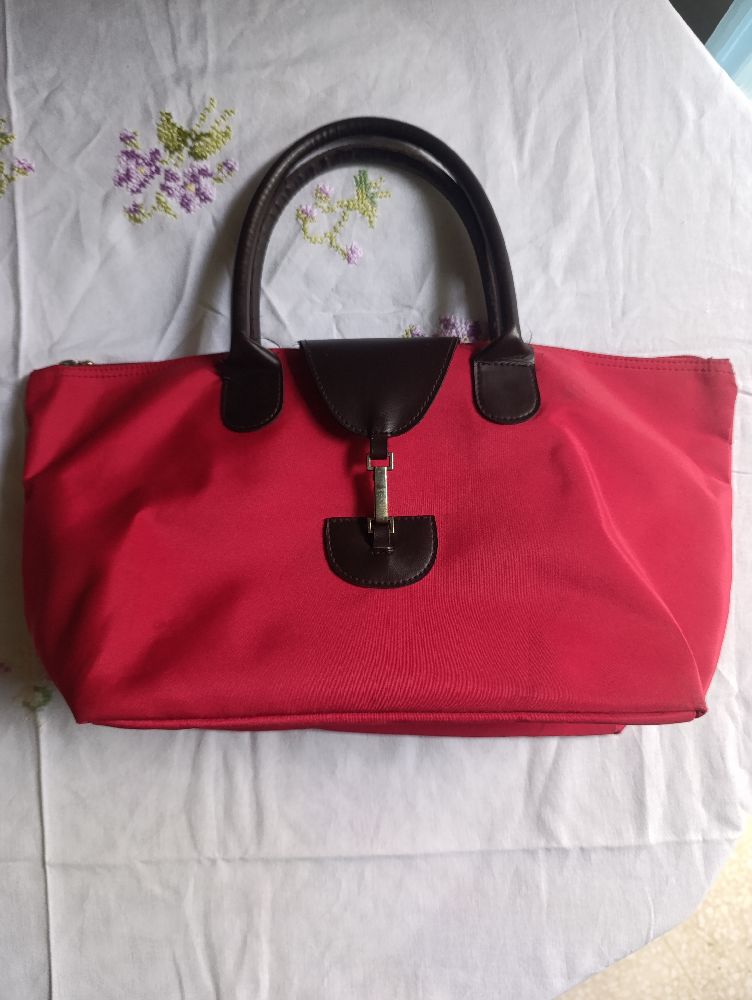 Un sac á main en bon etat de couleur rouge 