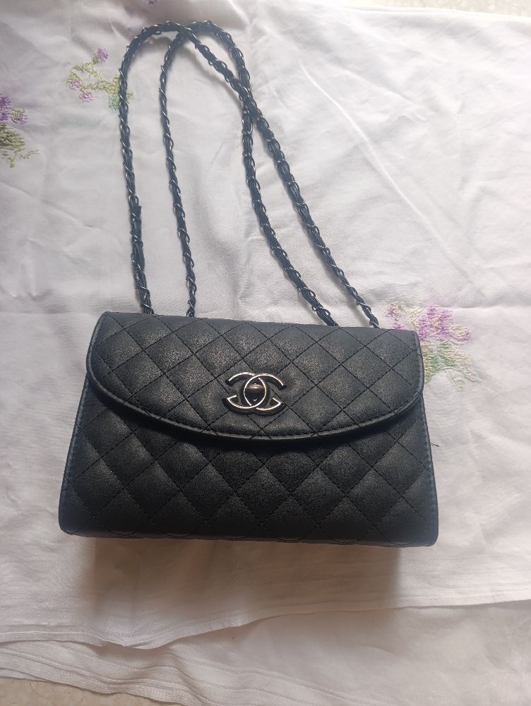 Un sac noir á bandoulliére rouge á l'interieur.