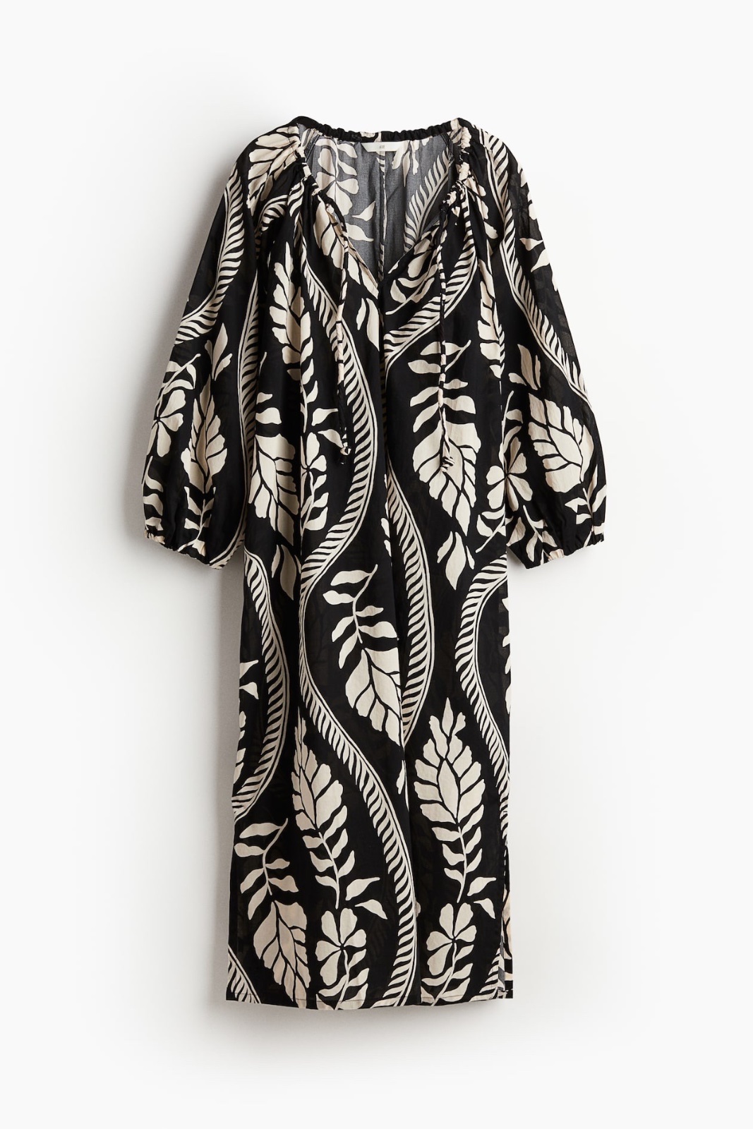 Robe noire et blanche à motif floral est un modèle H&M en coton aérien avec une encolure resserrable par cordon taille L 40/42/44