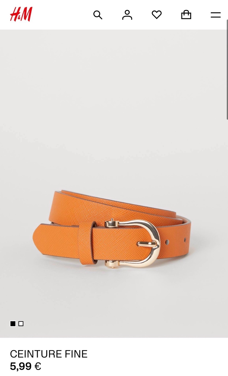 Une ceinture fine H&M en imitation cuir orange avec une boucle en métal doré