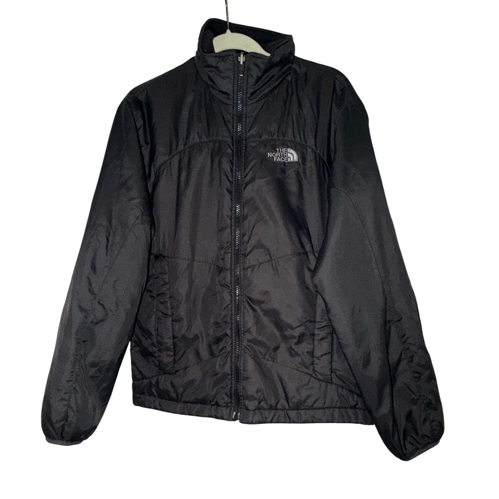  The North Face insulated or puffer jacket in black.