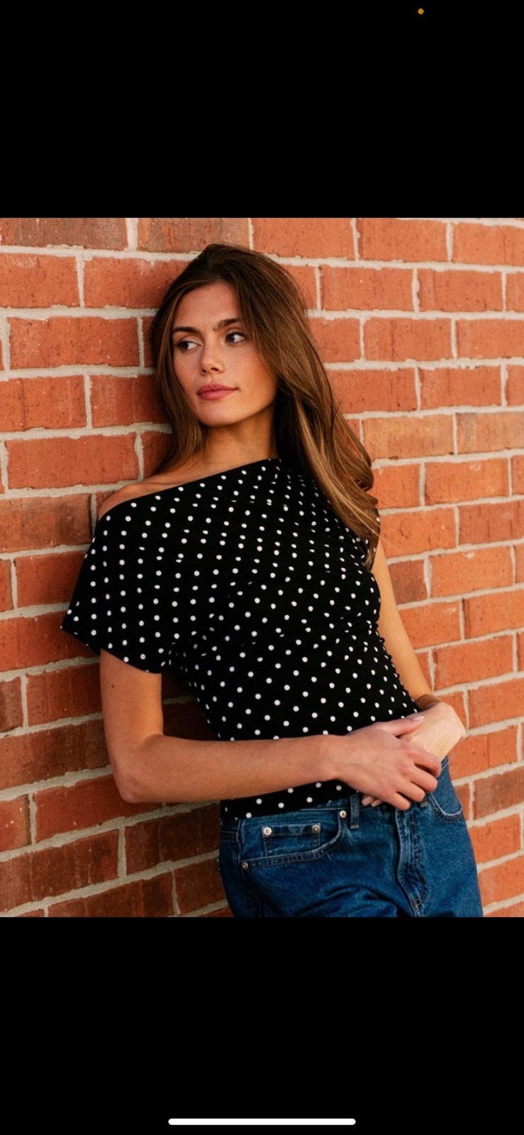 Black off-the-shoulder polka dot mini dress