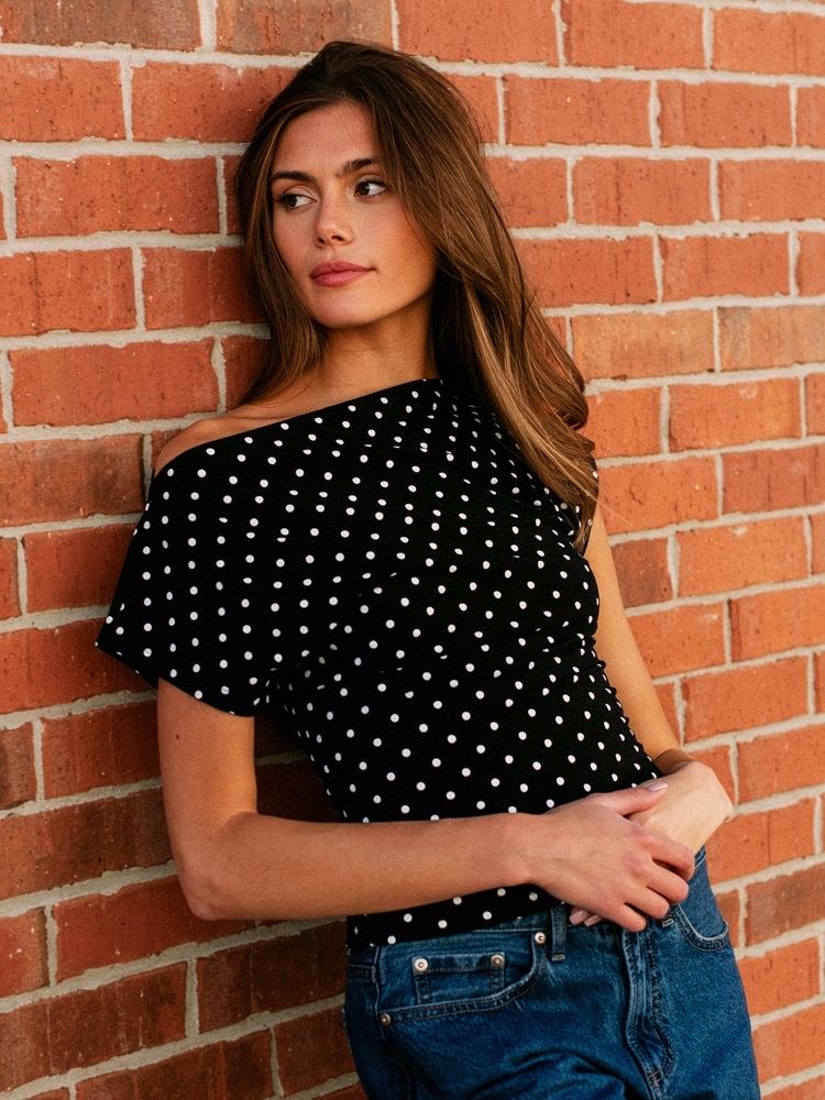 Black off-the-shoulder polka dot mini dress,